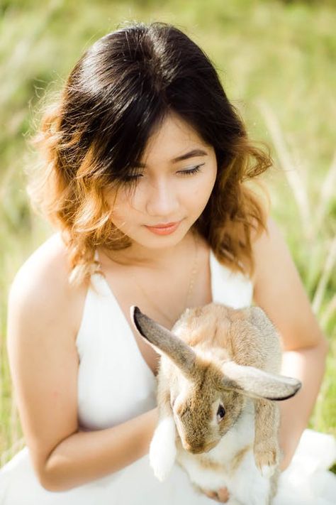 A woman in white top holding a rabbit😍 Person Holding Bunny Reference, Holding Bunny Pose, Woman Holding Rabbit, Person Holding Bunny, Holding Bunny, Rabbit Pose, Illustration Reference, Woman In White, Female Face