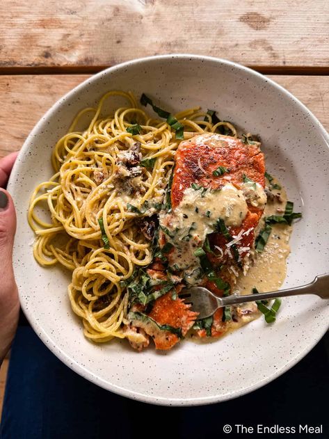 Tender, juicy salmon in a creamy sun-dried tomato garlic sauce with handfuls of fresh basil is one of the best dinners you'll ever make. I love Marry Me Salmon with pasta and a salad - it's just so good. #theendlessmeal #salmon #marrymesalmon #marrymechicken #dinner Salmon With Pasta, Salmon With Pasta Recipes, Salmon And Pasta, Salmon Recipes With Pesto Sauce, Spaghetti With Salmon Recipe, Salmon With Pesto Sauce, Creamy Pesto Salmon Pasta, Salmon Pasta With Sun-dried Tomato Cream Sauce And Spinach, Salmon Spaghetti