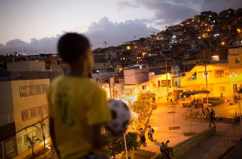 A young Brazilian footballer overlooking the favela in Rio de Janeiro Brazil Life, Street Football, The Beautiful Game, Summer Aesthetic, Rio De Janeiro, South America, Dream Life, At Night, Summer Vibes