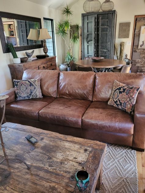 Rustic Leather Furniture Living Rooms, Wood And Leather Living Room, Farmhouse Living Room With Leather Furniture, Whiskey Leather Couch Living Rooms, Cottage Core Leather Couch, Brown Leather Couch Colorful Living Room, Old Leather Couch Living Room, Southwest Rustic Living Room, Brown Leather Couch Farmhouse