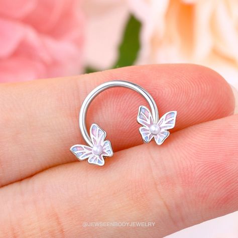 One package includes one piece septum ring. Bar Thickness: 16g(1.2mm); Inner Diameter: 10mm Material: 316L Stainless Steel This daith earring is design of pearl butterfly.Pink is very gentle and sweet.It makes you look more distinctive in the crowd,suitable for many occasions,such as parties,ceremony and so on.You can give this jewelry to your loved one on valentine's Day,Mother's Day,anniversary, birthday and so on. As winter passes, spring and summer come, all nature is full of life. Butterfli Cute Septum Rings, Daith Earring, Daith Rings, Helix Ring, Nose Ring Hoop, Septum Rings, Tragus Jewelry, Piercing Septum, Pearl Butterfly