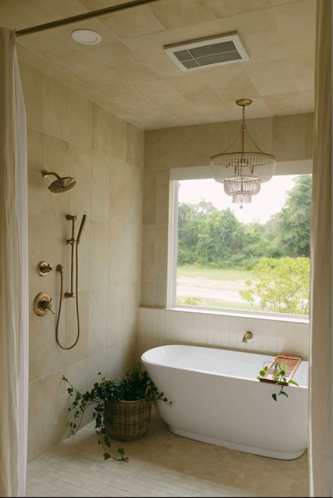 Tub, freestanding tub, neutral, neutral design, neutral tile, vertical tile, shower, chandelier, brass faucet, delta faucet, monotone design, tan tile, cream tile, cream shower Wet Shower Room Ideas, Tub Wet Room, Wet Area Bathroom, Wet Room Bathroom With Tub, Bathtub Bathroom Design, Plants In Shower, Wet Room Bathroom, Standing Tub, Bathroom With Tub