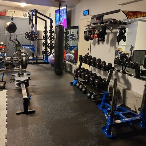 Garage gym with squat rack, boxing equipment, weights, sled and cardio equipment. Gym floors are black and blue. Garage Boxing Gym, Small Home Gym Ideas, Small Home Gym, Basement Gym, Home Gym Design, Gym Ideas, Custom Garages, Boxing Gym, Cardio Equipment