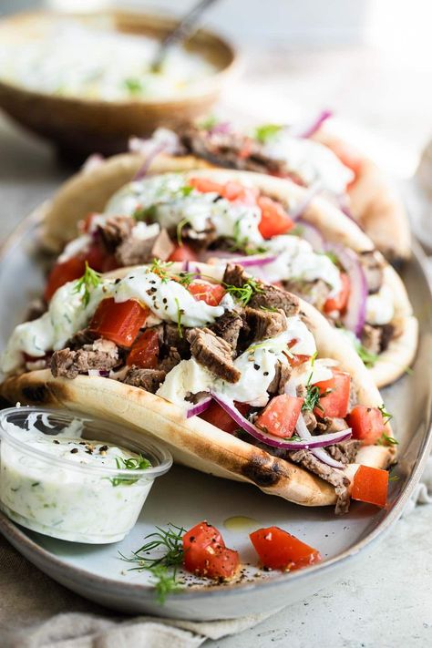 Flank steak stars in this street cart-inspired pita wrap recipe. Tuck the Greek-marinated Beef Gyros inside a fluffy pita bread, and top with homemade tzatziki sauce. Beef Gyro Recipe, Beef Gyros, Gyro Meat Recipe, Beef Gyro, Steak Wraps, Grilled Beef Recipes, Mediterranean Cooking, Pita Wrap, Pita Recipes