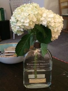 Wedding center pieces Bourbon bottle vase, woodford, hydrangea Bourbon Party Decor, Bourbon Party Decorations, Bourbon Themed Centerpieces, Derby Wedding, Bourbon Bottle Centerpiece Wedding Ideas, Bourbon Themed Wedding, Bourbon Party, Bourbon Dinner Party, Bourbon Decor