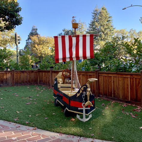 I made this pirate ship wagon (DIY) for my two little boys to trick or treat in. It’s made of light weight plywood, covering a spray painted step2 kids wagon. Complete with anchors that move, a sail that goes up and down, and cannons that shoot! Diy Pirate Ship Wagon, Viking Trunk Or Treat, Ship Trunk Or Treat, Pirate Ship Trunk Or Treat, Wagon Pirate Ship, Pirate Ship Wagon, Pirate Ship Halloween, Diy Pirate Ship, Diy Wagon