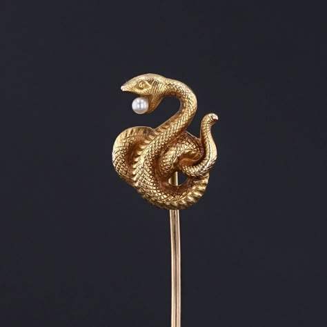 This antique 14k gold stick pin (circa 1880-1900) features a coiled snake with a pearl in its mouth. It bears the makers mark for Alling and Co. of Newark, NJ.  The pin head measures 0.6 inches from top to bottom by 0.45 inches wide with the entire pin length is 2.4 inches. It is in great condition. We have many other fantastic offerings of period fine jewelry posted on our Etsy store, so please consider browsing our other items. We send all items in individually packaged gift boxes and offer la Vintage Snake Jewelry, Vintage Snake-shape Jewelry For Formal Occasions, Elegant Gold-tone Snake Shaped Jewelry, Luxury Gold Snake-shaped Jewelry, Snake Brooch, Coiled Snake, Pin Head, Antique Gold Snake-shaped Jewelry, Newark Nj