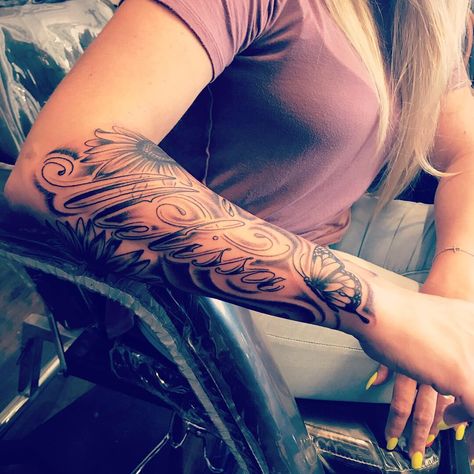 Half sleeve tattoo. Sunflowers and butterflies with my Sisters name 😇 Sleeve Tattoos With Names, Half Sleeve Name Tattoos For Women, Name Tattoo On Forearm For Women, Sleeve Tattoos Feminine, Name Sleeve Tattoo For Women, Sleeve Tattoo With Names, Sunflower Name Tattoo, Sunflower Tattoo With Name, Sunflower Sleeve Tattoo