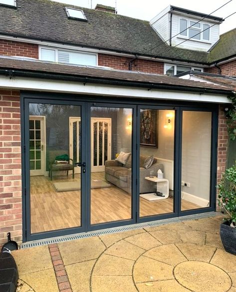 A set of bifold doors recently installed in a home in Surrey!💫⁠
⁠
With a convenient traffic door on one side, they offer the ultimate flexibility for those moments when you don't want to fully swing open the doors but still need access.⁠
⁠
Whether it's a quiet morning coffee on the patio or a lively evening gathering with friends, these bifold doors adapt to your lifestyle so effortlessly. They are perfect in the warmer months when you can open up the entire space onto the garden!⁠ Industrial Bifold Doors, Black Frame Bifold Doors, Black Steel Bifold Doors, Ventilated Bifold Doors, Bifold Doors Onto Patio, Bi Folding Doors, 1.8m Bifold Doors, Bifold Patio Doors, Accordion Doors