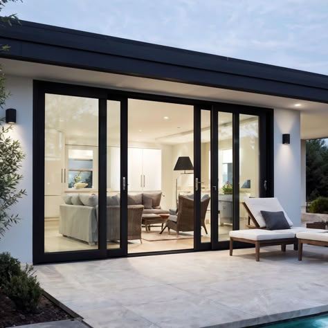 Find the perfect blend of style and functionality with our bifold patio doors. These elegant doors open up your home to the great outdoors, providing an unobstructed view and seamless transition between your indoor and outdoor living spaces. Crafted with high-quality materials, our bifold patio doors are designed for durability and energy efficiency, making them a practical and beautiful addition to any home. Experience the ultimate in modern design and convenience—upgrade your home with bifold patio doors today! Black Sliding Door To Patio, Family Room Patio Door, Large French Doors To Backyard, Family Room Bifold Doors, By Folding Doors Kitchen Extensions, Indoor Outdoor Living Doors, Trifold Outdoor Doors, Double Door Patio Doors, Modern Sliding Doors Exterior Patio