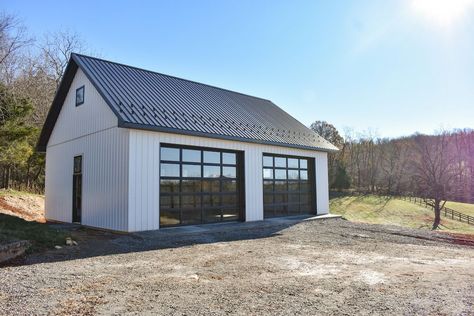 Separate Garage From House Modern, Garage With Glass Doors, White Garage With Black Doors, Metal Building With Glass Garage Doors, Detached Metal Garage Ideas, Firehouse Aesthetic, Exterior Garage Ideas, White And Black Garage, White Metal Garage