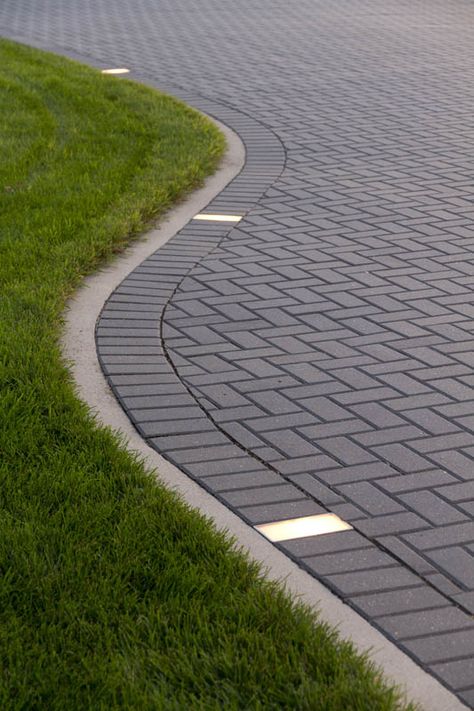 The addition of paver lights create a great accent to this Holland driveway. Driveways With Pavers, Lighted Driveway Ideas, Modern Pavers Driveway, Paver Driveway Designs, Pavers Lighting, Driveway Paving Design, Lighted Driveway, Driveway Lighting Ideas, Driveway Flooring