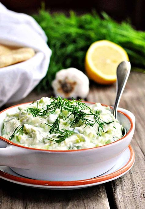 Tzatziki (pronounced zat-ZEE-key) is an authentic classic Greek garlic-yogurt sauce made with strained yogurt, cucumber, garlic, olive oil and salt. It often has fresh lemon juice along with a generous amount of mint or dill and is served as an appetizer ('meze' if you're in the Mediterranean) with fresh pita or vegetables for dipping, or as a dip for grilled meats like chicken and lamb. This easy and healthy recipe also works wonderfully as a spread for shawarmas or gyros (both pita or ... Best Tzatziki Sauce Recipe, Yogurt Tzatziki Sauce, Greek Yogurt Tzatziki, Hardy Meals, Greek Sauce, Greek Yogurt Sauce, Tzatziki Sauce Recipe, Garlic Olive Oil, Tzatziki Sauce