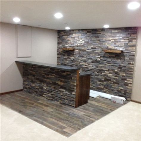 Adorn® Mortarless Stone Veneer Siding is perfect for those interior projects - check out this bar installed with our Ledgestone Series stone in Buckskin. Accent Wall Bar Area, Stone Accent Wall Behind Tv, Stone Bar Ideas, Diy Bar Ideas For Home, Stacked Stone Bar Ideas, Stone Front Bar, Stone Under Bar Counter, Home Bar Stone Wall, Stone Basement Bar