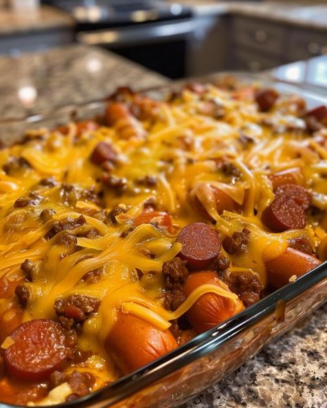 Lay some hotdog buns in a casserole dish and in no time, you'll have a dinner to die for Hot Dog Casserole, Chili Dog Casserole, Chili Cheese Dog Casserole, Baked Hot Dogs, Chili Cheese Dogs, Cheese Dog, Beef Casserole Recipes, Hot Dog Recipes, Chili Cheese