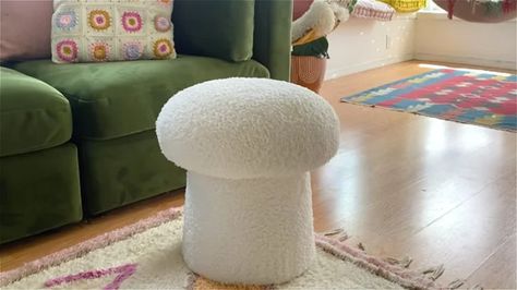 This DIY Mushroom Ottoman Isn't Just Cute, It's Functional Too How To Make A Mushroom Stool, Mushroom Ottoman Diy, Mushroom Pillow Diy, Diy Mushroom Stool, Storage Ottoman Diy, Mushroom Living Room, Diy Ottoman Ideas, Mushroom Footstool, Mushroom Ottoman