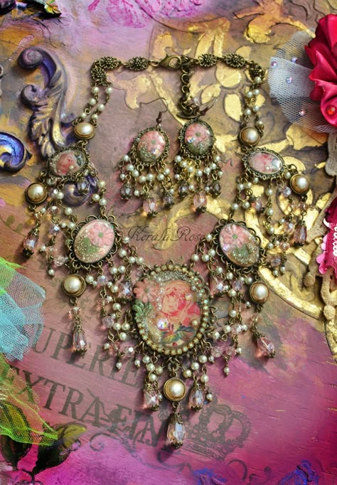 "This beautiful Feminine handmade necklace and earring set is made with Vintage rose images and vintage floral embroidery appliques resin-set into bronze metal frames with draped strands of faceted Pink crystal and cream pearl beads.  Crystal rhinestones and glass pearl dust decorate the pendants for an added texture and sparkle!  The chandelier earrings measure 3\" long x 1\" wide, in your choice of piercing. The back is a lobster clasp and extension chain. Bronze metals. *If you require a larg Vintage Floral Embroidery, Vintage Jewelry Diy, Vintage Jewelry Repurposed, Whimsical Jewelry, Rose Images, Cameo Jewelry, Jewelry Accessories Ideas, Craft Jewelry, Pearl Cream