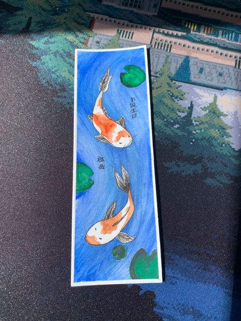 Its a bookmark with a koi fish design and a happy bithday grandma lettering on it. Made with watercolour Koi Fish Bookmark, Fish Bookmark, Watercolour Bookmarks, Watercolor Koi Fish, Bookmark Design, Bookmark Designs, Koi Fish Designs, Koi Watercolor, Watercolor Bookmarks