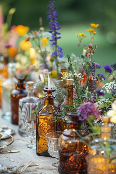 Elevate your wedding decor with a unique touch of the past. These vintage perfume bottles turned vases are filled with an array of herbs and wildflowers, perfect for a bohemian-themed celebration. 🌿🌼💐 A touch of nostalgia meets natural beauty for your special day. #WeddingInspiration #BohoWedding #CenterpieceIdeas #VintageDecor #FloralDesign #DIYWedding #EventStyling #WeddingFlowers Wildflower Boho Wedding Theme, Antique Glass Wedding, Eclectic Centerpieces, Wedding Wildflowers Decoration, Vintage Glass Wedding Decor, Wildflower Vintage Wedding, Diy Wildflower Wedding Decor, Wedding Herbs Decoration, Boho Bottle Centerpieces Wedding