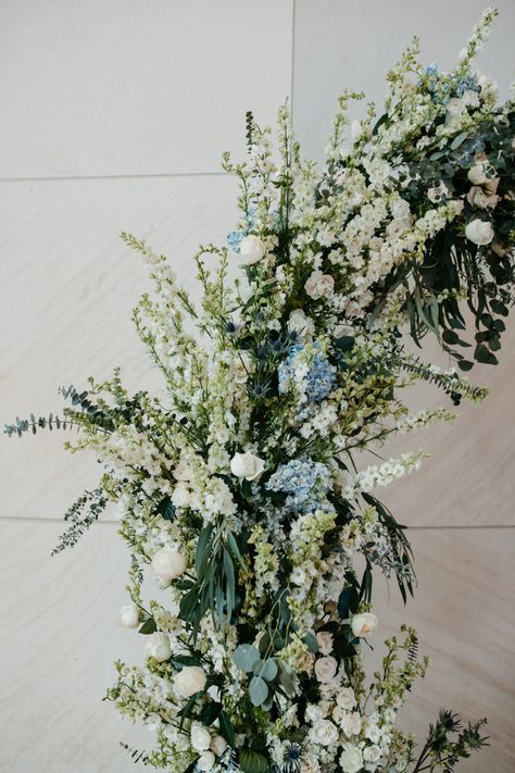 white and green with a hint of dusty blue makes for a dreamy arch. #weddingideas #weddingflowers #weddingphotography #weddinginspiration #weddingdecor #flowers #dustyblue Dusty Blue Arbor Flowers, White Green Blue Wedding Florals, Dust Blue Wedding Flowers, Dusty Blue Dark Green Wedding, Dusty Blue And Sage Green Wedding Arch, Green And Blue Wedding Bouquets, Sage Green And Blue Wedding Flowers, Blue Tones Wedding, Pale Blue And Sage Green Wedding