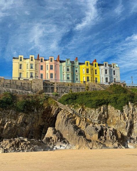 Exploring the street of colourful houses in Tenby, Pembrokeshire, Wales. Legend has it that the pastel shades of West Wales' harbours are a legacy of the fishermen forefathers of these small communities. Once, as the story has it, fishermen would paint their terrace homes around the dock in varying colours so they could recognise their own as they returned from the sea...~.~ Tenby Wales Aesthetic, Seaside Architecture, Tenby Wales, Brindleton Bay, Pretty Buildings, Wales Flag, Pembrokeshire Wales, British Seaside, West Wales