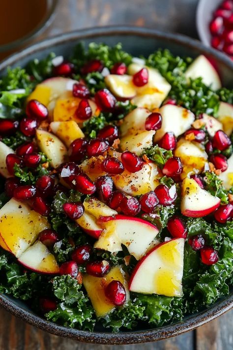 Delicious Kale and Pomegranate Salad topped with Maple Vinaigrette, perfect for festive occasions. Celebrate Thanksgiving or Christmas with this refreshing yet hearty recipe using fresh ingredients. Easy Paleo Salad, Massage Kale Salad, Kale Pomegranate Quinoa Salad, Salads With Almonds, Half Baked Harvest Kale Salad, Hearty Kale Salad, Pomogranette Salads, Holiday Salad With Pomegranate, Shredded Kale Salad