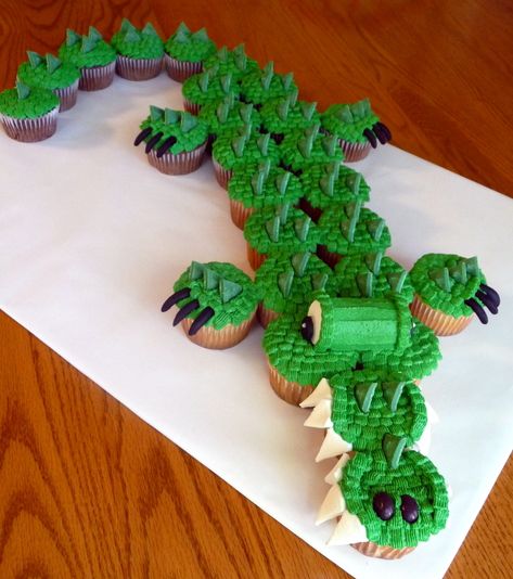 As seen in Hello Cupcake book.  My kids school mascot is a crocodile!  Eyes and teeth used marshmallows.  Scales used green Wilton candy melts cut into triangles.  Black mmf claws and nostrils. Alligator Cupcakes, Crocodile Eyes, Wilton Candy Melts, Book Cupcakes, Pull Apart Cake, Hello Cupcake, Pull Apart Cupcakes, Creative Cupcakes, Cake Central