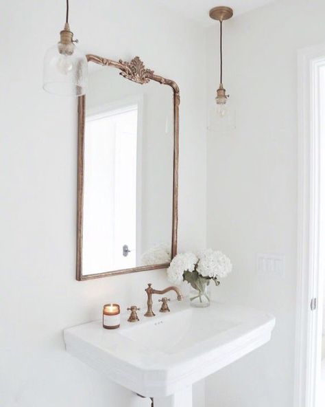 Farmhouse Bathroom, bronze gooseneck faucet, glass pendants and vintage gold mirror over pedestal sink. perfection in a white bathroom Parisian Bathroom, French Country Bathroom, Elegant Bathroom, Bath Room, Vintage Bathroom, White Bathroom, Guest Bathroom, Architectural Digest, Bathroom Inspiration