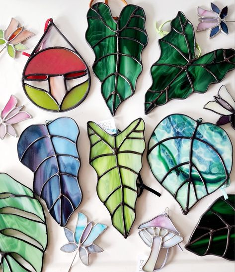 Colorful collection of stained glass suncatchers in mushroom, leaf and flower shapes Stained Glass Stencils, Stained Glass Leaves, Glass Fusion Ideas, Glass Diy, Stained Glass Ornaments, Glass Fusion, Stained Glass Flowers, Stained Glass Diy, Stained Glass Crafts