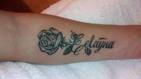 Rose tattoo with a name stem. Rose With Name Stem Tattoo, Rose Name Tattoo, Shoulder Name Tattoo, Rose Tattoo With Name, Name Tattoos On Arm, Heart Tattoos With Names, Rib Tattoos For Guys, Sister Tattoo Designs, Mama Tattoo