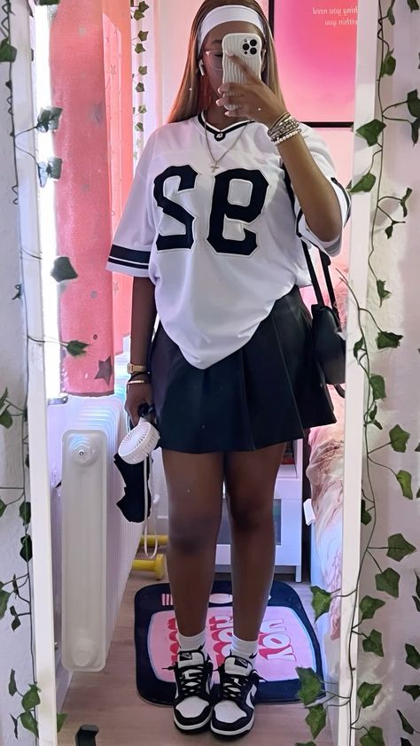 Baggy Tshirt And Skirt Outfit, Dunks With Skirt Outfit, Casual Outfit Baddie, Pleated Skirt With Sneakers Outfit, Baggy Shirt Skirt Outfit, Corset And Pleated Skirt Outfit, Pleated Skirt With Graphic Tee, Black Nike Dunks Outfit Woman, Skirt Outfits Black Women Sneakers