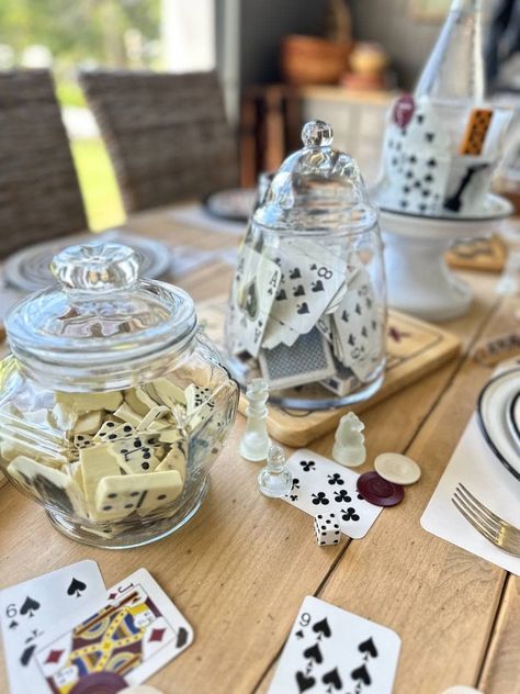 It's tablescape day for my dinner club and this month is all about game night. I have some winning game night party table setting ideas and inspiration to share with you. This table theme was so fun to create. I was able to scour my game closet at home and use playing cards, poker chips, dice, and a chess set to incorporate into my table setting. I picked up a few vintage game boards at a thrift store for a few dollars and a package of paper napkins with a game theme to complete my table. Board Game Centre Pieces, Game Night Set Up, Poker Birthday Party Ideas, Board Game Night Ideas, Vintage Activities, Poker Party Ideas, Vintage Game Boards, Game Night Table, Game Night Decorations