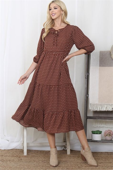 The easiest transition piece from Fall to Winter, this tiered midi will not disappoint. - Features white dot pattern across this brown tiered midi dress - Elastic sleeves & a midi hemline - Gauze like material - Loose fit | Model is 5'9" wearing a size Small **due to screens & filters color may vary from pictures** Modest Outfits Fall, Midi Dress Outfit Fall, Midi Dress Styling, Fall Dress With Boots, Spring Modest Outfits, Modest Fall Dresses, Elementary School Teacher Outfits, Fall Winter Work Outfits, Semi Casual Dresses