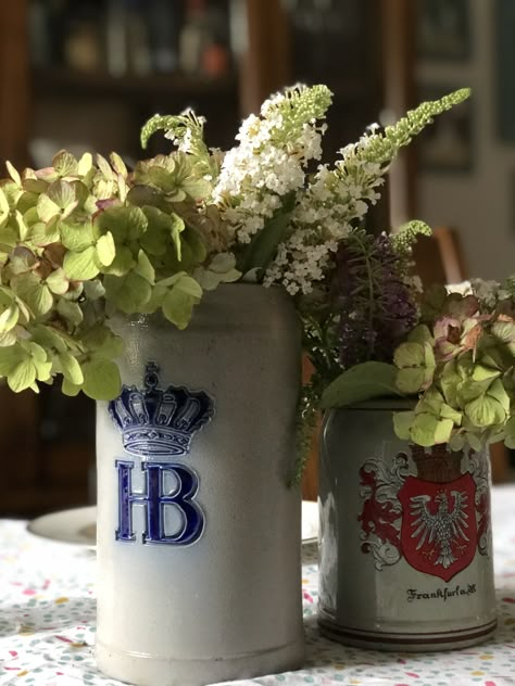 #beerstein #centerpiece #fordad | Joy in the Midst Creative Beer Stein Flower Arrangements, Oktoberfest Centerpieces Diy, Oktoberfest Floral Arrangements, German Wedding Decorations, Beer Stein Centerpiece, Oktoberfest Centerpieces, Beer Garden Wedding, Oktoberfest Table, Pretzel Party