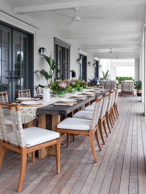 Rope and teak chairs align at a long wood and concrete outdoor table featuring a crochet table runner and styled floral tablescapes. Concrete Outdoor Dining Table, Concrete Outdoor Table, Outdoor Dining Tables, Wood And Concrete, Outdoor Patio Ideas, Long Dining Table, Teak Dining Chairs, Casas Coloniales, Teak Chairs