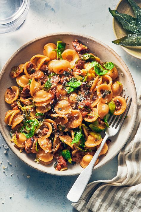 This easy vegetarian pasta features spicy plant-based sausage, crispy sage, and brussels sprouts. It takes less than 30 minutes to make! The creamy sauce is flavored with onions and garlic—and comes together while the pasta cooks. (Vegan option, Gluten free option) Pasta With Brussels Sprouts, Sausage Brussel Sprouts Pasta, Brussel Sprouts Pasta, Brussels Sprouts Pasta, Brussel Sprout Pasta, Easy Vegetarian Pasta, Evergreen Kitchen, October Recipes, Spicy Sausage Pasta