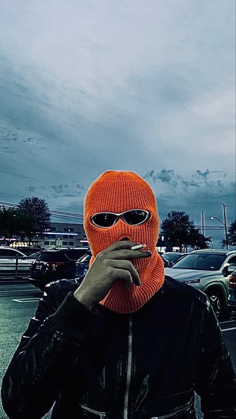 a person smoking a cig with an orange balaclava on and some aesthetic 2000s sunglasses with a leather jacket on a costco parking lot Orange Balaclava, Balaclava Aesthetic, 2000s Sunglasses, Aesthetic 2000s, Sunglasses Outfit, Rave Outfit, Parking Lot, Rave Outfits, Egg