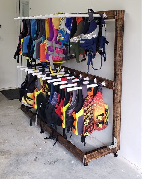 Lake House Towel Storage, Lakehouse Organization, Boathouse Organization Ideas, Lakehouse Storage, Life Jacket Storage Ideas Garage, Kayak Organization, Boat House Storage Ideas, Water Ski Storage Ideas, Lake House Garage