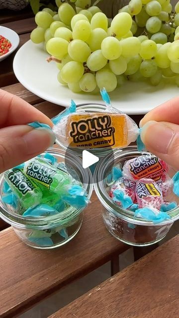 Tinka | Fruits & Snacks on Instagram: "Jolly Rancher Candy Grapes 🍬🍇

Ingredients:
- Jolly Rancher Flavor Fruit Punch, Lime & Orange
- Fresh Green Grapes
- Nerds Candy

Wash and dry the grapes, then skewer them. Unwrap the Jolly Rancher candies and melt them in a microwave-safe bowl until smooth. Dip each grape into the melted Jolly Rancher, then immediately roll in Nerds candy. Place the coated grapes on a baking sheet and let them chill in the freezer or fridge. Enjoy your delicious Candy Grapes!

Comment ‘recipe’ and I will DM you the full recipe!

#grapes #candygrapes #jollyranchergrapes #jollyrancher #candy #frozen #frozengrapes #snack #snackidea #fruits #fruitlover #fruitasmr #summersnacks #asmr #asmrvideo #asmrsound #asmrcommunity #healthysnacks #healthyrecipes #easysnack #quicksn Jolly Rancher Covered Fruit, Candied Grapes Jolly Rancher, Jolly Rancher Grapes, Coated Grapes, Jolly Rancher Candy, Jolly Rancher Flavors, Grape Snacks, Candied Grapes Recipe, Candy Place