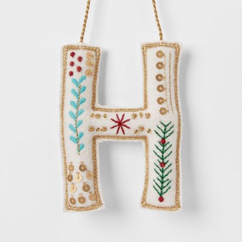 Hang an ornament on the tree for any family member's name with this Embroidered Fabric Monogram Letter Christmas Tree Ornament from Wondershop™. Made from wool and felt, this monogram ornament is designed as a letter of the alphabet in white with embroidered holiday accents. Designed with a top string loop, it's easy to hang from the branches of your tree. Welcome to the Wondershop™. Baby’s First Christmas Ornament Embroidered, Embroidered Initials Letters, Cardstock Ornaments, Golden Retriever Felt Ornament, Christmas Letters, Holiday Embroidery Patterns, Embroidered Christmas Ornaments, Monogram Letter S, Jesse Tree Ornaments