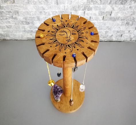 "Pendulum Display Stand with Sun and Moon Engrave, Pendulum Holder, Dowsing Pendulum Stand You can save a lot of space while keeping all of your pendulums safe in one place with this beautiful handmade display stand. It is made of birch plywood and beech wood. Sun and Moon engraving is painted to black. There are 18 slots on top for hanging the pendulums. Each slot is 3mm wide and there is 20mm distance between each slot. The base part of the stand can also be used for displaying your small crys Pendulum Stand Diy, Pendulum Display, Pendulum Holder, Pendulum Work, Moon Engraving, Recycle Projects, Wood Sun, Diy Recycled Projects, Dowsing Pendulum