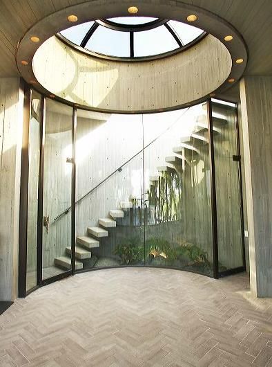 Circular entrance hall with striking glass enclosed staircase and unique skylight Circular Roof Architecture, Circular Entrance, Circular Roof Design, Unique Entrance Design, Circle Skylight, Circular Skylight, Staircase Skylight, Round Skylight, Circular Room