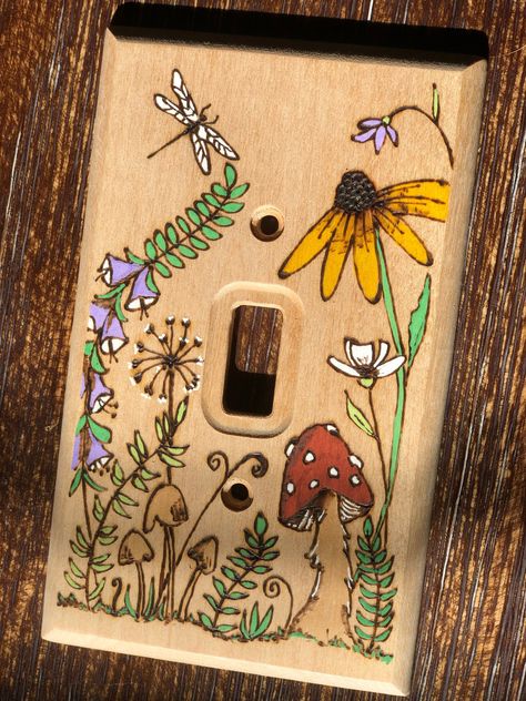 **This is a Made to Order item** Bring the natural world indoors with this sweet meadow design that has been burned into the wood. It is a lovely way to customize a room, whether your style is cottagecore, boho, farmhouse, eclectic, etc.  This light switch cover fits the standard single toggle light switch and includes brass-colored machine screws that blend beautifully with the color of the birch wood. The flowers, mushrooms, and dragonfly are painted and the rest is unfinished wood. The front Mermaid Light Switch Cover, Flower Light Switch Cover, Wood Burned Light Switch Cover, Cute Light Switch Art, Home Decor Cottagecore, Clay Lightswitch Cover, Light Cover Painting Ideas, Light Switch Painting Ideas Aesthetic, Boho Light Switch Cover