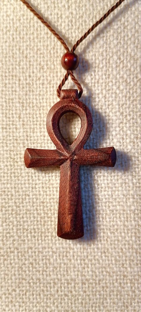 This Ankh pendant necklace is made of black walnut wood. Equipped with an adjustable length cotton cord. It comes with a collapsible canvas bag. #velvetcarvings #ankhnecklace Ahnk Symbol, Wood Necklace Pendant, Ankh Necklace, Wood Jewelery, Black Walnut Wood, Symbol Necklace, Wood Necklace, Deer Antlers, African Jewelry