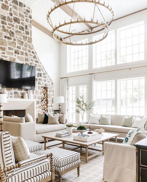 This white shiplap living room with light wood ceiling beams and uneven stone fireplace features a brass two tier chandelier. The chandelier hangs over a light wood square coffee table accompanied by beige couches. Japanese Minimalist, Inspire Me Home Decor, Dream Spaces, A Living Room, Farmhouse Living, Room Layout, Decoration Design, Patio Decor, Interior Design Living Room