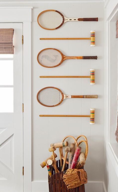 vintage tennis rackets and croquet mallets Lake Laundry Room, Tennis Interior Design, Decorating With Tennis Rackets, Collegiate Aesthetic Decor, Old Tennis Rackets Ideas, Vintage Rackets Decor, Vintage Lakehouse Decor, Old Tennis Racket Decor, Vintage Tennis Racket Decor Wall Art