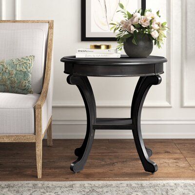 Break away from traditional square and rectangular end tables with this round one! It's made from engineered wood and features a solid, antiqued finish for some rustic farmhouse style. This table showcases molded detail up top, and four legs with scroll detailing for elegant appeal. Plus, there's also a small lower shelf for a remote or a petite decorative object. Full assembly is required - be sure to have a screwdriver on hand. Hand-curated by Kelly Clarkson. Color: Antique Black | Kelly Clark Pedestal End Table, End Table Wood, Black End Tables, Tall End Tables, Side Table Decor, Kelly Clarkson Home, Wood Pedestal, Living Room End Tables, Wood End Tables