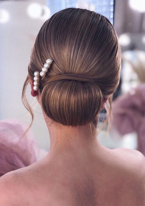 Hair is smoothed and gathered into a low bun for a classic look. #avedaibw Hair In A Bun, Geometric Hair Clip, Bridal Hair Updo, Elegant Wedding Hair, Classic Hairstyles, Low Bun, Wedding Hairstyles Updo, Wedding Hairstyle, Hair Do