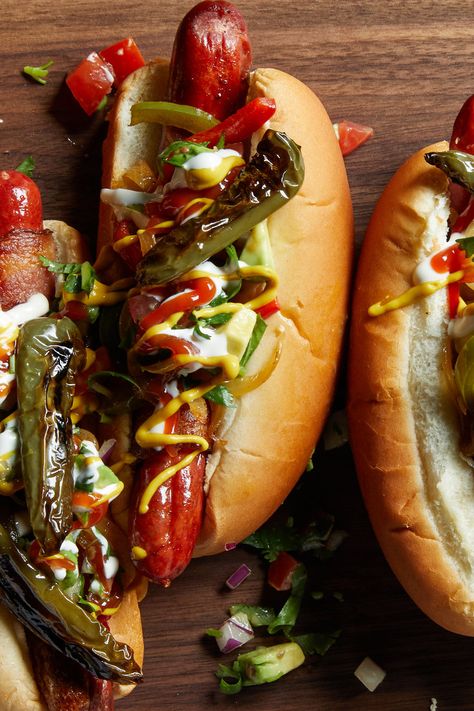 Mexican Hot Dogs Recipe - NYT Cooking Mexican Hot Dogs Bacon Wrapped, Mexican Hot Dogs Recipes, Mexican Hot Dogs, Sautéed Peppers, Bacon Wrapped Hotdogs, Wrapped Hot Dogs, Dog Restaurant, Sauteed Peppers, Fingerfood Party