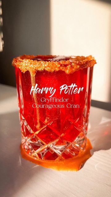 ChampagneAng | Ang Sturino on Instagram: "Bringing back the #harrypottercocktails series ✨🪄 this is your sign to have a themed cocktail party 🧙‍♀️❤️💛 Day 1 of the series. Comment which #hogwartshouses you want to see next! Gryffindor Couragous Cran - cranberry concentrate ice cubes - soda water - 1 oz vodka - 1tbs agave syrup - rim glass with agave syrup & gold sprinkles #vodkacranberry #vodkacran #vodkacocktail #cranberrycocktail #harrypotterrecipes #harrypotterparty #harrypotterpartyideas #harrypotterdrinks #harrypottercocktail #gryffindoraesthetic #gryffindorcocktail #halloweencocktails #halloweencocktail #halloweendrinks #halloweenthemed #halloweenpartyideas #harrypotterhalloween #halloween2023 #harrypotteredits #hogwartsaesthetic #hogwartshouse #hogwartshousesedit" Vodka Cran, Harry Potter Cocktails, Harry Potter Drinks, Gryffindor Aesthetic, Cranberry Vodka, Gold Sprinkles, Cranberry Cocktail, Harry Potter Food, Harry Potter Halloween